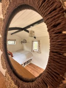 a mirror in a room with a bed at The Hideaway in Fakenham