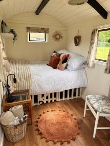 a bedroom with a bed in a small room at The Hideaway in Fakenham
