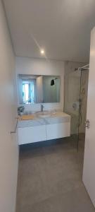 a bathroom with a sink and a shower at Stunning Lobos View in Câmara de Lobos +16 photos