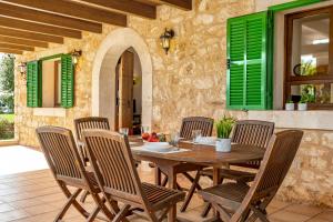 a dining room with a wooden table and chairs at Son Garrot mit Pool und Wifi in Santanyi