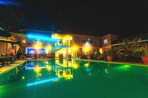 a swimming pool at night with lights on it at Okaseni Lodge in Arusha