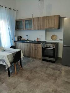a kitchen with a stove and a table in it at Sunrise Apartments - Aegean Blue in Kalymnos