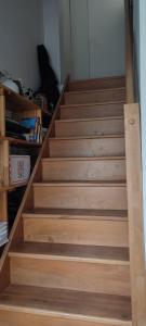 a set of wooden stairs in a room at Logement calme et ensoleillé dans maison de ville in Villejuif