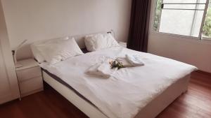 un letto bianco con lenzuola bianche e fiori sopra di Valley View a Ko Chang