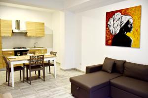 a living room with a couch and a table and a kitchen at SGC Boa Vista Apartments in Sal Rei