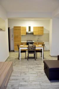 a kitchen with a table and chairs in a room at SGC Boa Vista Apartments in Sal Rei