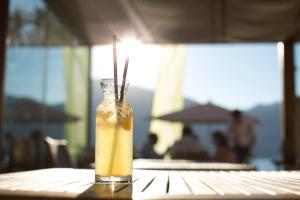 a drink in a glass vase on a table at BAIA in Brenzone sul Garda