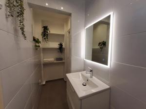 a white bathroom with a sink and a mirror at Charmante villa proche de la gare et de Paris in Les Pavillons-sous-Bois +21 photos