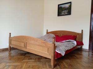a wooden bed in a room with a wooden floor at Елітні апартаменти в історичному центрі in Chernivtsi