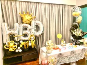 a room with a table with a crown and balloons at LUXURY 3BR Penthouse I The Shore Hotel & Residence I Seaview I Poolview I 6-9Pax in Melaka