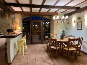 a kitchen and dining room with a table and chairs at Casa Rural La Ferrería in Vinuesa