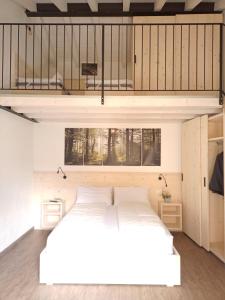 a bedroom with a large white bed in a room at appartamenti Residenza 1928 in Tremosine Sul Garda