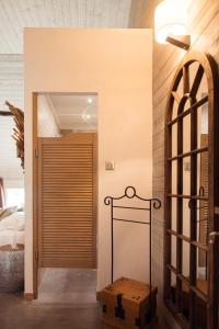 a bedroom with a door leading to a bed at Abri Cosy - Suite Romantique in Saint-Gilles