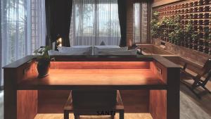 a room with a bed with a vase on a table at SANTI beach retreat in Ban Rang Pla