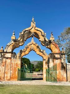 an old gate with an arch in a park at Surrounded by Cenotes, Mayan sites and Haciendas in Seyé