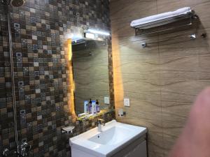 a bathroom with a sink and a mirror at Mukhtar Homes Bahria Town Lahore in Lahore