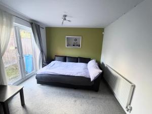 a bedroom with a bed in a room with a window at Cheerful Heeley Home in Heeley