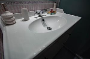a white sink in a bathroom with at Castle Hillside Apartment in Budapest +6 photos