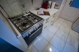 a stove top oven in a white kitchen at Castle Hillside Apartment in Budapest