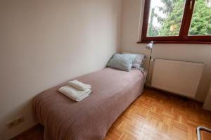 a small bedroom with a bed with two towels on it at Castle Hillside Apartment in Budapest
