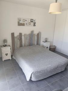 a bedroom with a bed and two night stands at La Cazaline in Cazaux