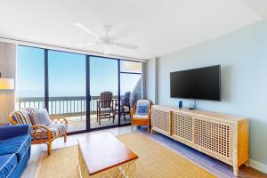 a living room with a flat screen tv and a couch at Century I 1622 in Ocean City