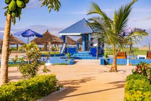 ein Resort mit einem Pool, Palmen und Sonnenschirmen in der Unterkunft Seaview 1-Bed Suite on Cape Point Beach Bakau in Bakau