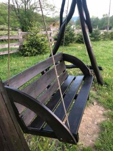 a swing in a yard with a grass field at IT-Hutorok in Turʼya Paseka