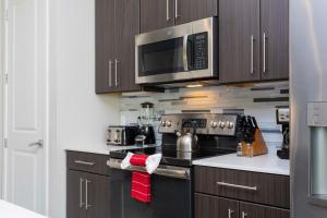 a kitchen with a stove and a microwave at Breathtaking Vacation Home with Private Hot Tube 168 in Davenport