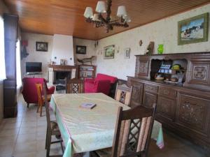 a living room with a table and a dining room at Gîte Saint Michel 2 étoiles in Moulin-Mage +17 photos