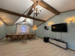 a large room with a dining table and a flat screen tv at JETISY COMPLEX in Taraz