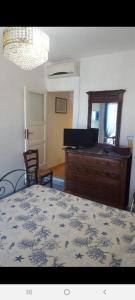 a bedroom with a bed and a table and a piano at La casetta di Giovanna in Marettimo
