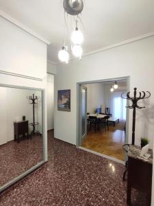 a living room with a mirror and a dining room at Volos center, St Nicholas Square, XENIOS in Volos