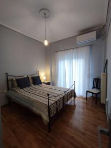a bedroom with a bed in a room at Volos center, St Nicholas Square, XENIOS in Volos
