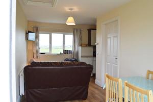a living room with a couch and a table at The Getaway, Miltown Malbay in Miltown Malbay