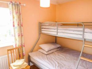 a bunk bed room with two bunk beds and a window at The Getaway, Miltown Malbay in Miltown Malbay