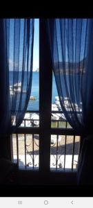 a window with a view of the beach and the ocean at La casetta di Giovanna in Marettimo