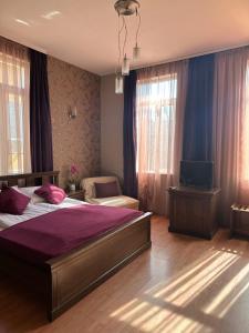 a bedroom with two beds and a tv in it at Vidin Hotel in Vidin