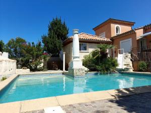 a swimming pool in front of a house at viarhona in Montélimar