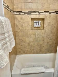 a bathroom with a bath tub with a towel at “Beautifull Cozy Studio…With Private Entrance” in Las Vegas