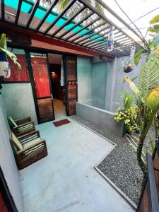 an outdoor patio with a pergola and a hot tub at La pinchi " Pinchi's Bed " in Gampola