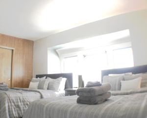 a bedroom with two beds with towels on the bed at Steps Away From Hospital - 2 Queen Bed - City View in Pittsburgh