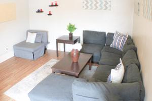 a living room with a couch and a table at Steps Away From Hospital - 2 Queen Bed - City View in Pittsburgh +19 photos