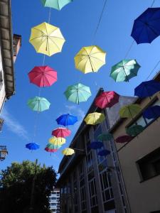 a bunch of umbrellas flying in the sky at Les Marmottes in Arpajon-sur-Cère
