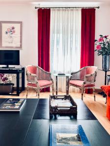 uma sala de estar com cortinas vermelhas e uma mesa em Casa de la Playa em Vega de Espinareda