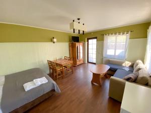 a room with a bed and a couch and a table at Prowincja Dębki in Dębki +97 photos