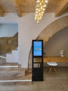a screen in a room with stairs and a table at Atrium in Castellammare del Golfo