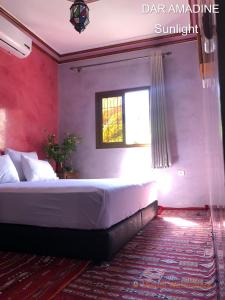 a bedroom with a large bed with a window at Dar Amadine in Imlil