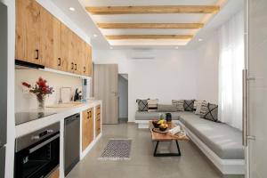a kitchen and living room with a couch and a table at Villa Jardin De Stelida in Stelida