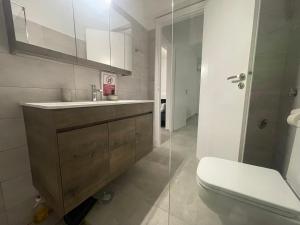 a bathroom with a sink and a toilet at Sparkling dream in Saronida +11 photos
